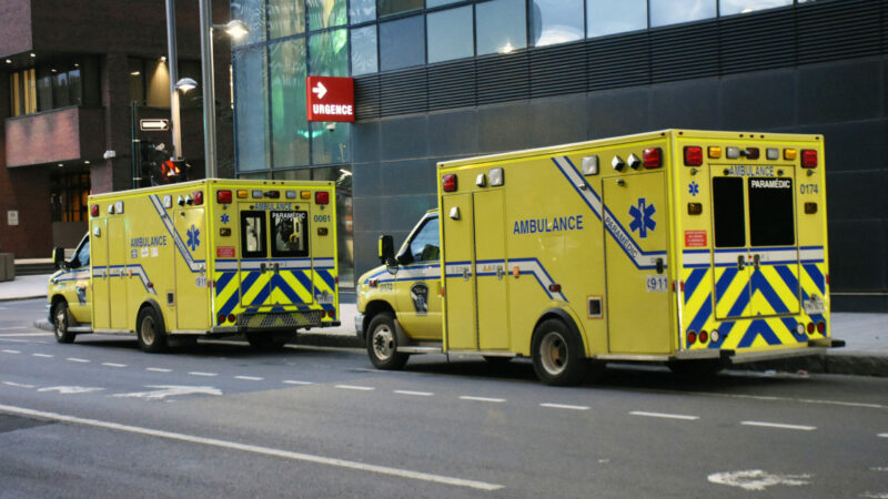 Ambulance, Land Vehicle, People, Building Exterior, Advertisement Sign, Tree Scene In Downtown Montreal Quebec Canada